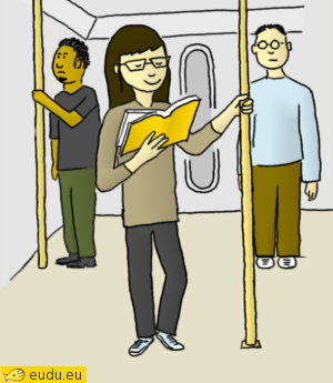 Een meisje staat met een boek in de metro.